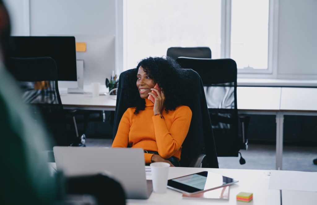 Focused data analyst in reviews SQL data on her laptop.