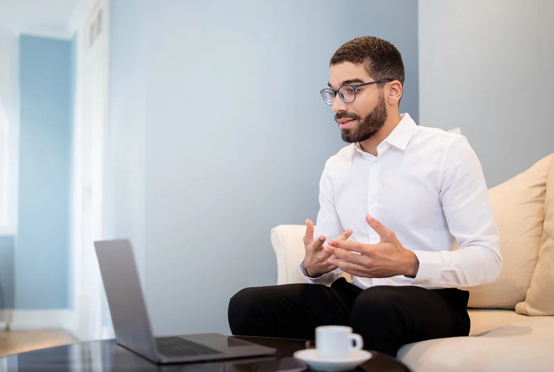 Professional discussing responses during an online interview, evaluated for communication skills and collaboration style.