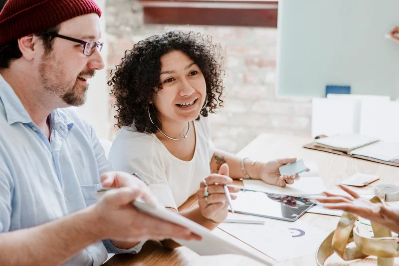 Two colleagues collaborating on hiring needs in an office setting, representing employer partnerships and talent support in Kitchener IT recruitment.