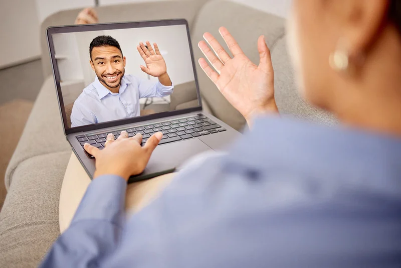 A confident recruiter reviewing candidate profiles on a laptop, symbolizing STACK IT’s focus on technical precision and cultural fit when building technology teams.