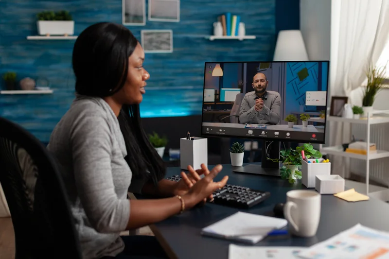 Hiring professional reviewing candidate submissions with a peer to verify screening accuracy before shortlisting.