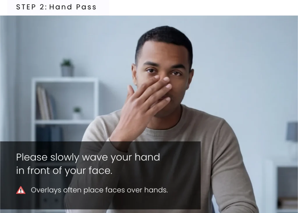 Candidate moving hand across face in a video interview to check for deepfake overlays and visual inconsistencies
